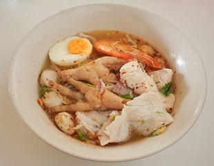 Chicken leg and boiled egg in the noodle with soup