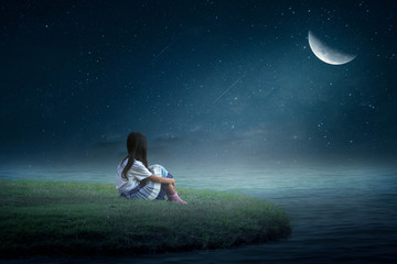 Fototapeta na wymiar young woman sitting on the moon