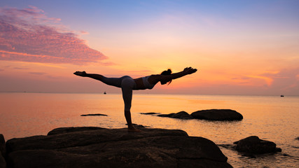 Asian girl practice Yoga on the beach Sunrise morning day