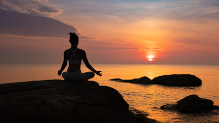 Asian girl practice Yoga on the beach Sunrise morning day