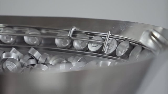 aluminium caps for glass bottles on a medical solution conveyor line selective focus medical industry