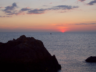 Beautiful calm sea ocean with  sunset sky at rock beach 