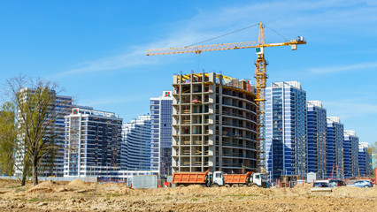 Fototapeta na wymiar Panoramic view of the construction of residential houses in the microdistricts. Space for text. Cityscape concept.