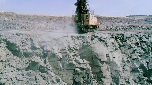 drilling rig drills granite for stowing explosives. slow motion Industrial extracting rock or minerals