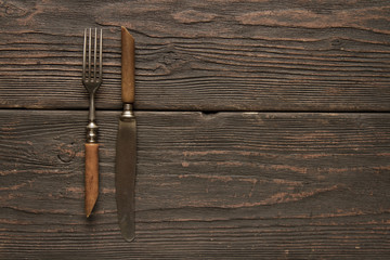 Old fork and knife on the table