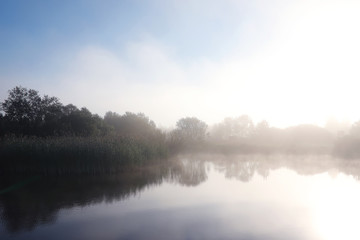 Obraz na płótnie Canvas Fog in the lake. Morning nature water white fog.