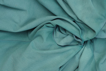 Close-up sectional full frame view of torn down old and turquoise green umbrella canvas fabric