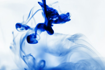 Puffs of paint in water. The dissolution of the dye in water. Water pollution. Concept art creativity.