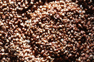 A set of grain cereals. Rice, buckwheat and millet groats in a wooden tray. A grocery set of cereals. Import of grain.