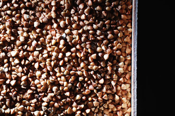 A set of grain cereals. Rice, buckwheat and millet groats in a wooden tray. A grocery set of...