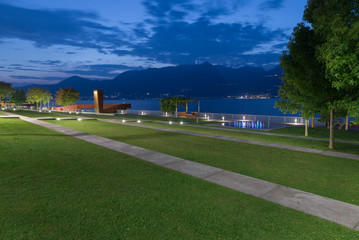 Modern lakeside promenade at dusk. Luino lakefront on Lake Maggiore, Italy