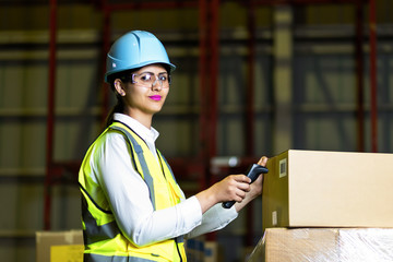 Young latina woman working in the warehouse.