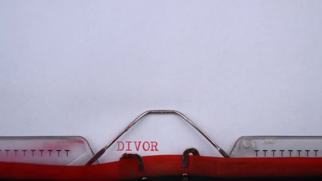 Divorce tips - phrase printed on an old typewriter in red letters, close up. vintage inscription
