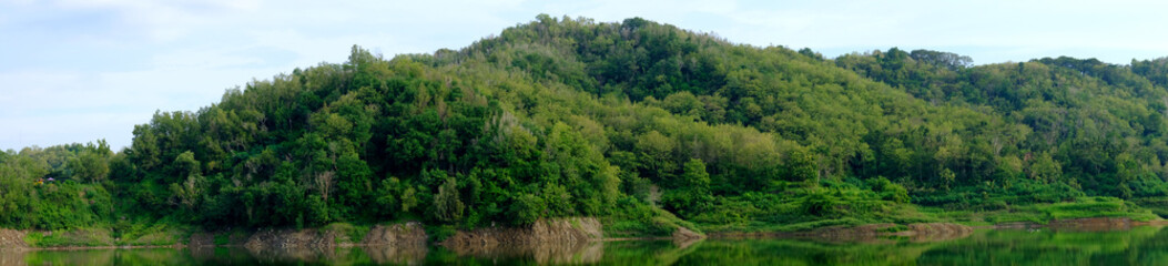 Fototapeta na wymiar green hills with water reflection