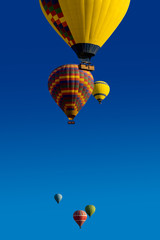 Multicolored hot air balloons on a blue sky with copy space for your text. Romantic weekend in the seventh sky or a tourist poster about your dreams of journey in vivid colors.