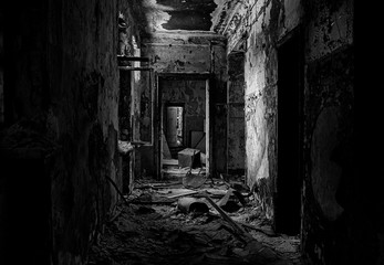 Fototapeta na wymiar Scary black and white corridor in an old abandoned house