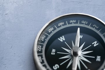 Brass antique classical compass on concrete desk © BillionPhotos.com