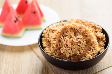 Sweet crispy rice mixed with watermelon juice with cane sugar drizzle, Local Thai snack (Khao Tan Nam Tangmo)