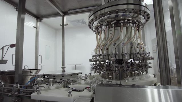 glass bottles on a medical solution conveyor at filling station medical industry