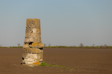 old medieval monument  among a plough lands