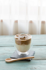 Whipped dalgona coffee on a wood background - ダルゴナコーヒー