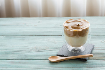 Whipped dalgona coffee on a wood background - ダルゴナコーヒー