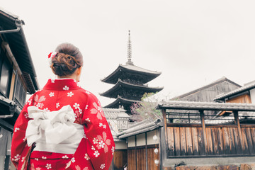 Asian woman wearing traditional Japanese kimono walking in the old town of Kyoto, Japan