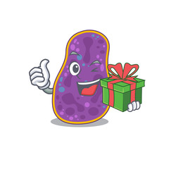 Smiling shigella sp. bacteria cartoon character having a green gift box