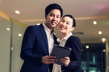 Happy business couple with tablet