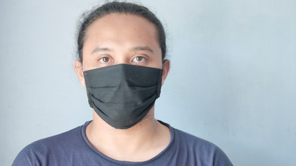 portrait of a man wearing cloth face mask