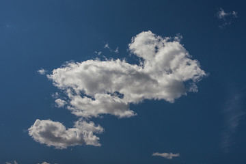 White cumulus clouds in the blue sky