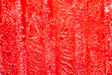 red candle surface, details of colored wax - scented candle for decoration