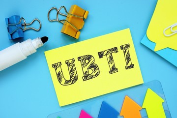 Financial concept about Unrelated Business Taxable Income UBTI with phrase on the piece of paper.