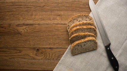 Wholemeal bread sliced on wooden table