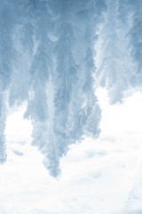 Blue crystal ice grotto cave with icicles, broken ice and snow. Winter landscape. 