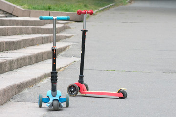 Two children's scooters on an alley in the park. In a coronavirus pandemic, children remain in quarantine at home.