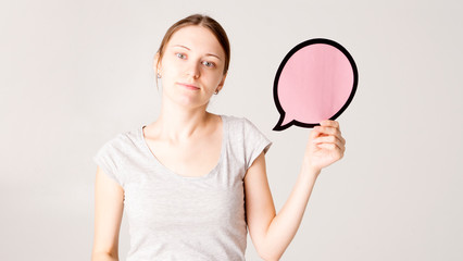 Surprised happy woman in shirt holding blank speech bubble