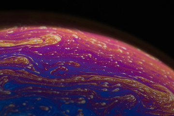 a soap bubble like a planet on a black background