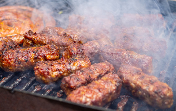 minced meat rolls or mici cooking on barbecue traditional romanain balkan ottoman dish 1st of may labor day celebration 