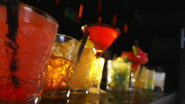 Cocktail Drinks Lined Up on a Bar Table During a Night Party