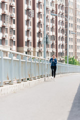 A young Asian Chinese woman is running