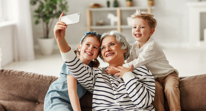 Grandmother taking selfie with grandchildren