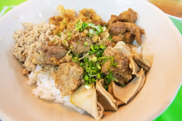 Rice with pork and offal topped with a bit of soup called Kao-Tom-hang. One of most popular local restaurants in Thailand.  