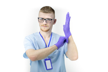 young male doctor or nurse in glasses wears blue rubber gloves looking at camera isolated on white background copy space treatment concept, health care professional concept