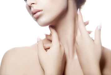 Partial beauty portrait of young woman with perfect skin touching neck with sensual hands. Facial...