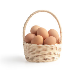 Eggs in the wicker basket isolated on the white background