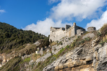 Fototapeta na wymiar The Doria Castle (1164-XIX century) of Porto Venere or Portovenere town, UNESCO world heritage site, on the rocky coast along the Mediterranean Sea. La Spezia, Liguria, Italy, Europe