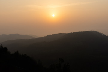 Golden sunrise on the mountain range of yercaud in Tamil Nadu India.