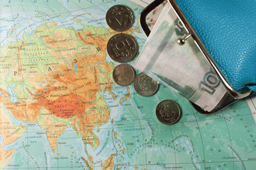 RUSSIAN money is on the geographical map of five thousand rubles in a blue purse. travel concept.
