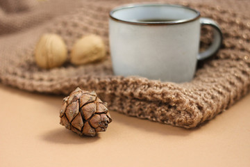 Obraz na płótnie Canvas autumn background. coffee mug on a brown background. cozy warm atmosphere